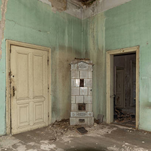 Interior of an abandoned mansion. Empty room deserted and derelict. The interior of an abandoned castle. Damaged and demolished fireplace