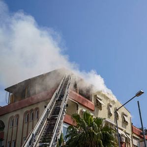 Burning fire with large smoke on the apartment house roof in the city, Antalya, Tukey