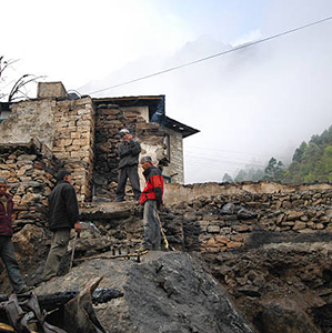 Lukla, Nepal - May 9, 2006: workers rebuilding burned-out houses after fire event at the town of Lukla in the Khumbu region, Nepal